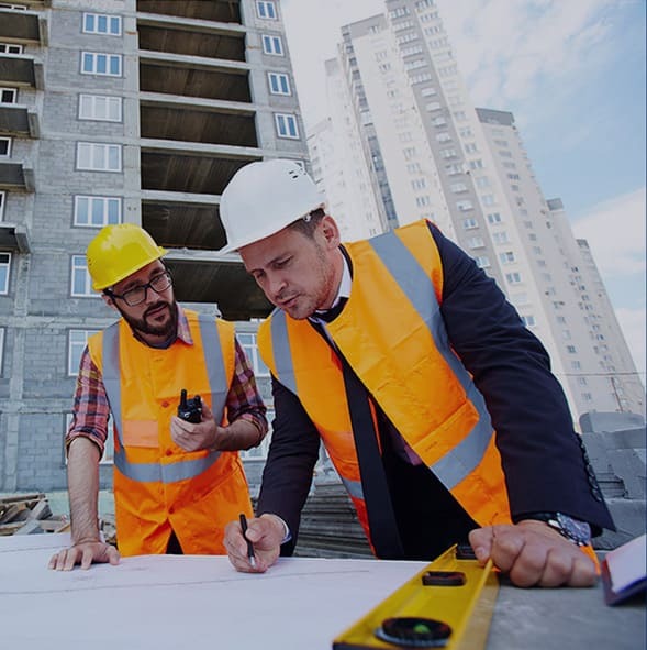 Engineers providing construction services and planning at a building site.
